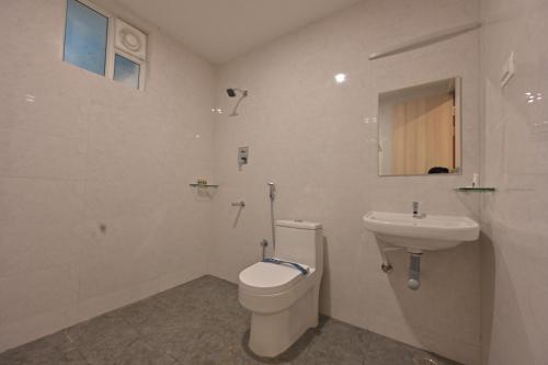 a bathroom with a toilet and a sink at CR RIVERA in Madurai