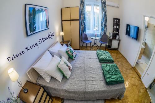 a bedroom with a large bed in a room at Summertime Apartments in Zadar