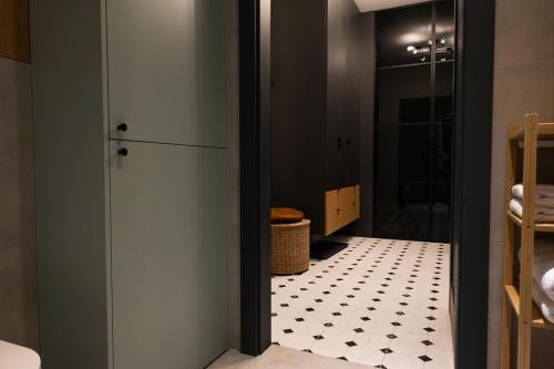 a bathroom with a black and white tiled floor at Jezyce Good Place Free Parking in Poznań