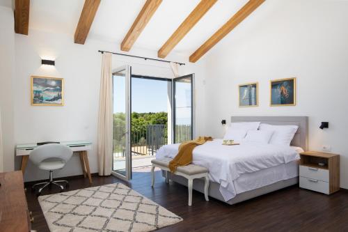 a bedroom with a bed and a desk and a window at Dolce Bacio in Kavran