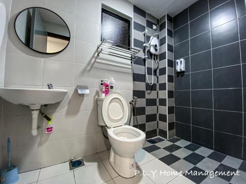 a bathroom with a toilet and a sink and a mirror at Crystal Cozy Suite PoolView Netflix Waterpark@ Ipoh Station 18 in Ipoh