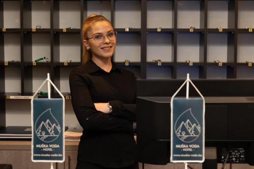a woman standing in front of a podium at Hotel Muška voda in Kladanj