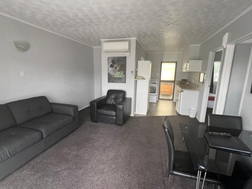 a living room with a couch and a table at Avenue Motel Palmerston North in Palmerston North