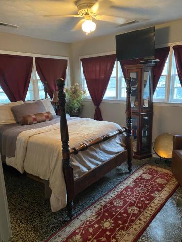- une chambre avec un grand lit et des rideaux rouges dans l'établissement Coombs Manor on the Mountain, à Ripley