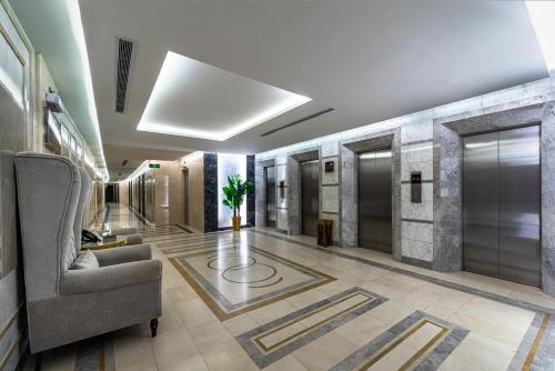 a lobby with a couch and a chair in a building at Best Western Ajyad Makkah in Makkah