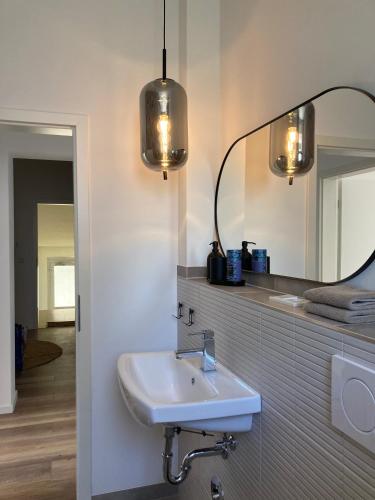 a bathroom with a sink and a mirror at Haus am Stadttor in Hattingen