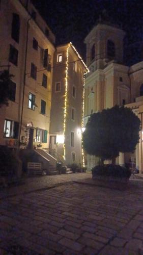 a building with lights on the side of it at night at DANTES in Pieve di Teco
