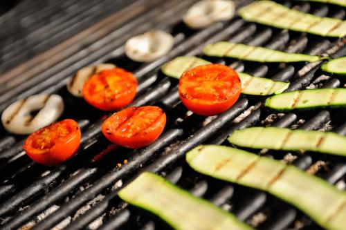 a group of tomatoes and mushrooms on a grill at Baia Degli Aranci Suite & Apartments in Vieste