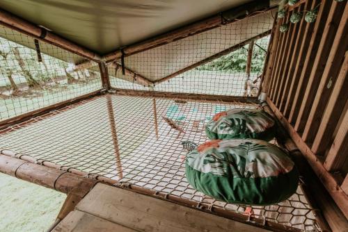a bird cage with two green balls in it at Kampari in Delfstrahuizen