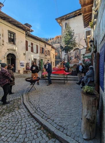 a group of people standing around in a street at B&B Piccolo Tibet in Lavenone