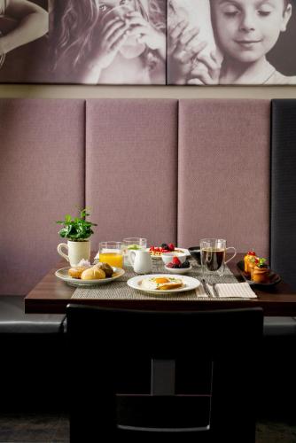 a table with two plates of food on it at Hotel Ines in Cattolica