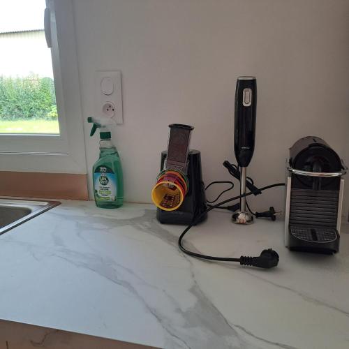 a kitchen counter with a radio and other items on it at Gîtes de l'AKWABA in Buzet-sur-Baïse