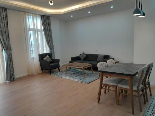 a living room with a table and a couch at Zemilo Hotel Apartment in Addis Ababa