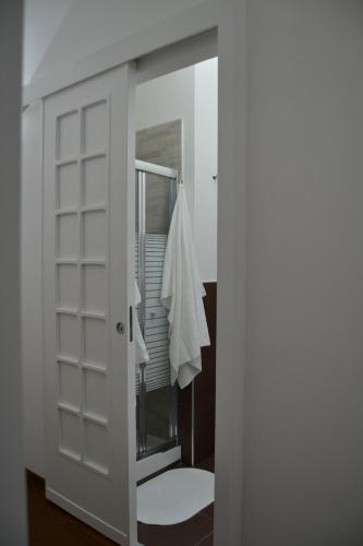 a bathroom with a mirror and a white door at B&B Paolo e Mariella in Palermo