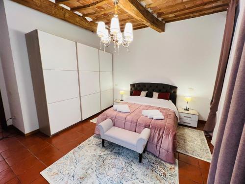 a bedroom with a large bed and a chair at Il cretto bianco in Città di Castello