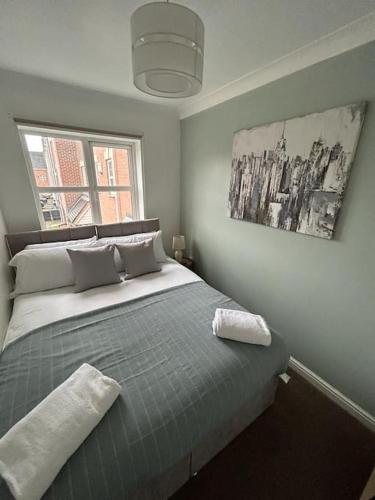 a bedroom with a large bed with a window at Modern & Comfortable with Free Parking in Bedford