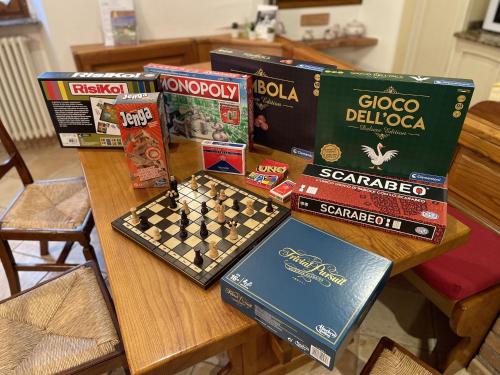 a wooden table with chess boards and books on it at Mazzetti Country House-Vita in campagna con giardino in Vimignano
