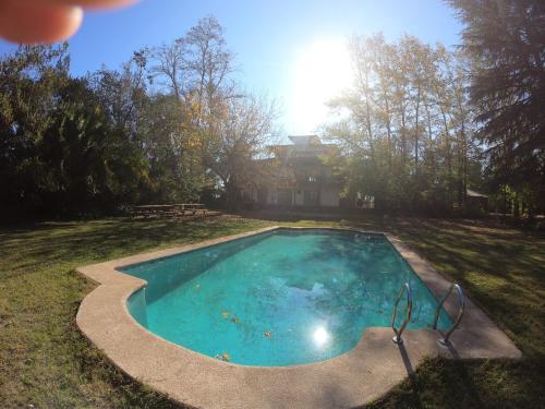 a swimming pool in the yard of a house at Casa Origen in Pirque