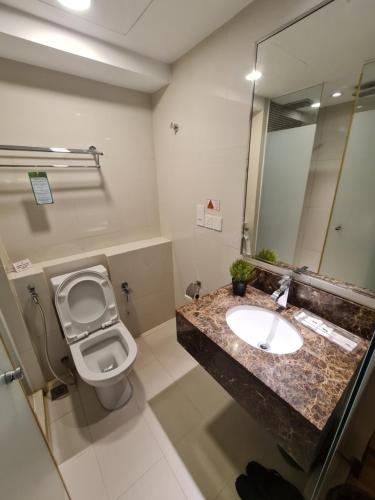 a bathroom with a sink and a toilet at BV3 Studio Type with swimming pool in KK City Centre in Kota Kinabalu