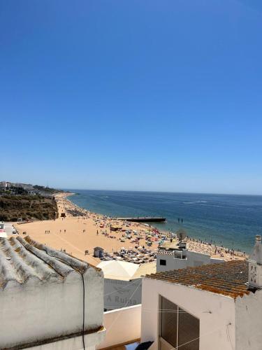 a view of the beach from the roof of a building at Vista del Mar Guest House in Albufeira