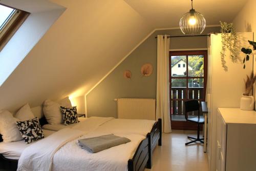 a attic bedroom with a bed and a window at "Altjessen 57" in Pirna