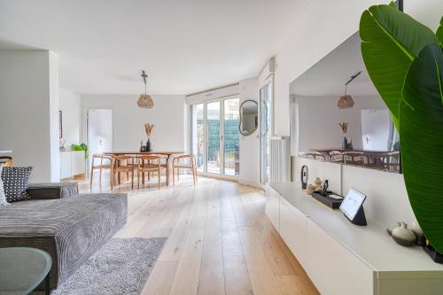 un salon avec un canapé et une table dans l'établissement Luxueux appartement Paris proche Tour Eiffel Champs Elysées La Défense, à Puteaux