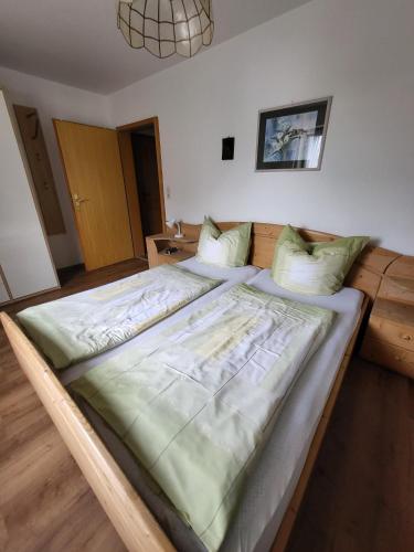 a large bed in a room with at Landhaus Weiß in Bad Reichenhall