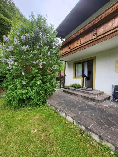a house with a flowering tree in front of it at Landhaus Weiß in Bad Reichenhall
