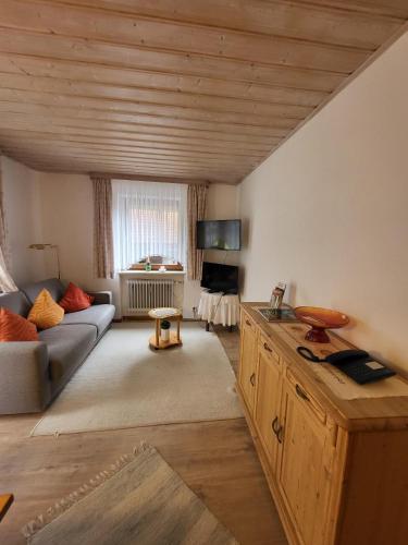 a living room with a couch and a table at Landhaus Weiß in Bad Reichenhall