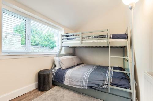 a small bedroom with bunk beds and a window at St Andrews - 5 min walk to centre in St Andrews