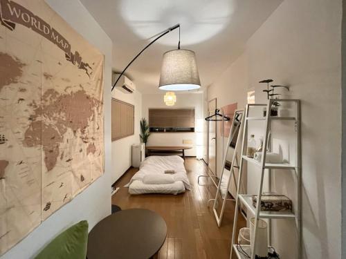 a room with a bed and a map on the wall at Kawasaki Sakula in Kawasaki