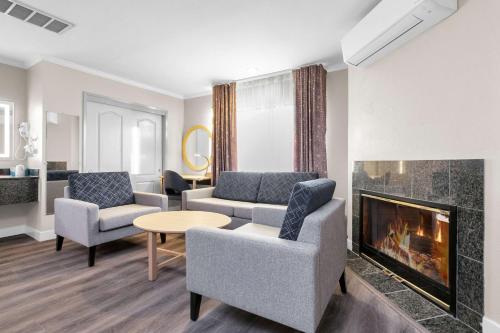 a living room with two couches and a fireplace at SureStay by Best Western San Francisco Marina District in San Francisco