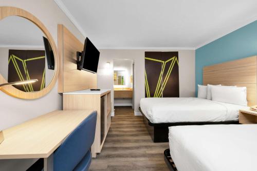 a hotel room with two beds and a mirror at SureStay by Best Western San Francisco Marina District in San Francisco