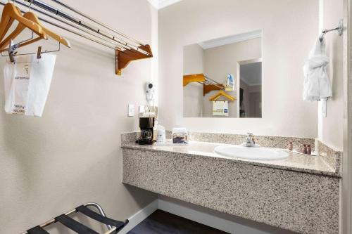 a bathroom with a sink and a mirror at SureStay by Best Western San Francisco Marina District in San Francisco