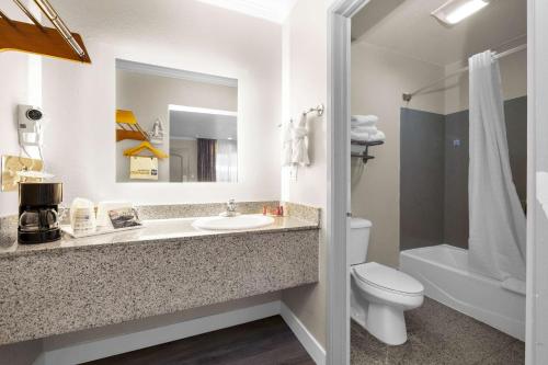 a bathroom with a sink and a toilet and a mirror at SureStay by Best Western San Francisco Marina District in San Francisco