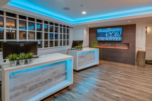 a lobby of a roxy hotel with a tv on the wall at The Row Hotel; BW Signature Collection in San Jose