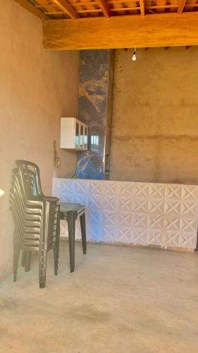 duas cadeiras e uma mesa num quarto em area de lazer cinuca em Serrana