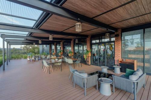 an outdoor patio with tables and chairs and windows at Modern-eco apartment in Sandown