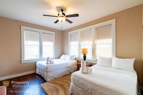 a bedroom with two beds and a ceiling fan at Breakfast Club - U of Tampa Flat in N Hyde Park in Tampa