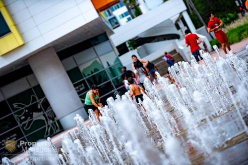 a group of people standing behind a water fountain at Breakfast Club - U of Tampa Flat in N Hyde Park in Tampa