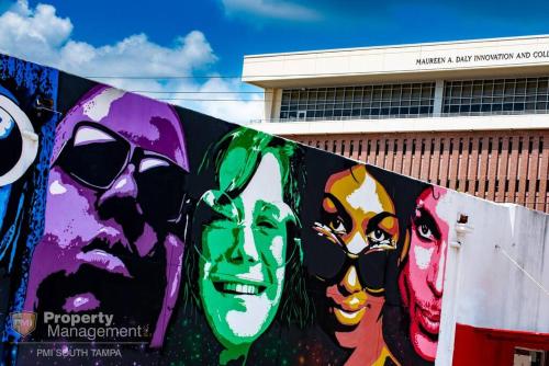 a wall with paintings of people on it at Breakfast Club - U of Tampa Flat in N Hyde Park in Tampa