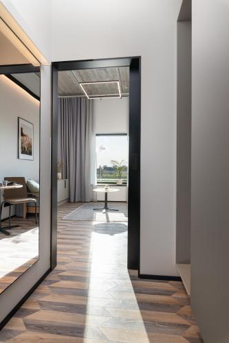 a hallway with a view of a living room at Väo Keskus Modern Guest Apartments in Tallinn