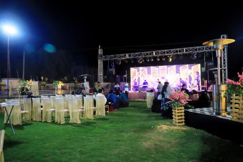 a group of tables and chairs in front of a stage at Ananda Resort in Pushkar