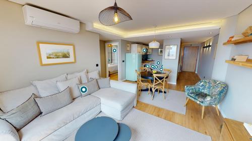 a living room with a white couch and a table at Rooftop Marina l by Madeira Best Apartments in Funchal