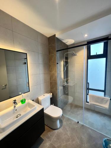 a bathroom with a toilet and a sink and a shower at The Axon Bukit Bintang By Cozy White in Kuala Lumpur