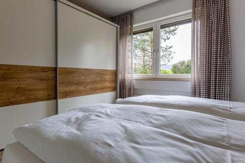 a bedroom with two beds and a window at Ferienwohnung Aartalblick Willingen in Willingen