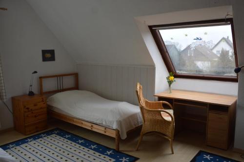 a bedroom with a bed and a desk and a window at Harten in Büchen