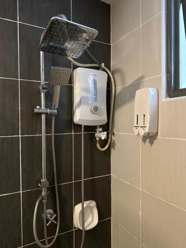a shower in a tiled bathroom with a shower at Evo Soho in Bandar Baru Bangi