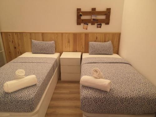 two beds in a small room with two mattresses at Roós, design loft near the sea. in Barcelona