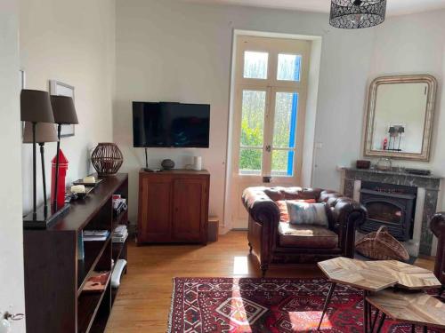 A television and/or entertainment centre at Charming holiday home in a beautiful setting